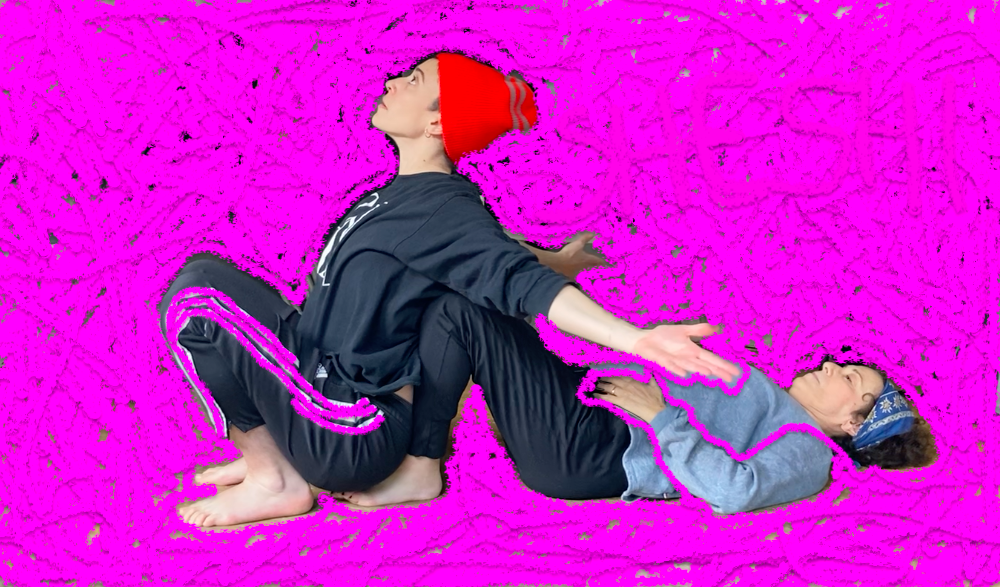 image from lily gold's new work in progress. A hand drawn pink background. lily's mother lays on the unseen floor, knees raised. lily, wearing an orange cap and black sweats, leans against them.