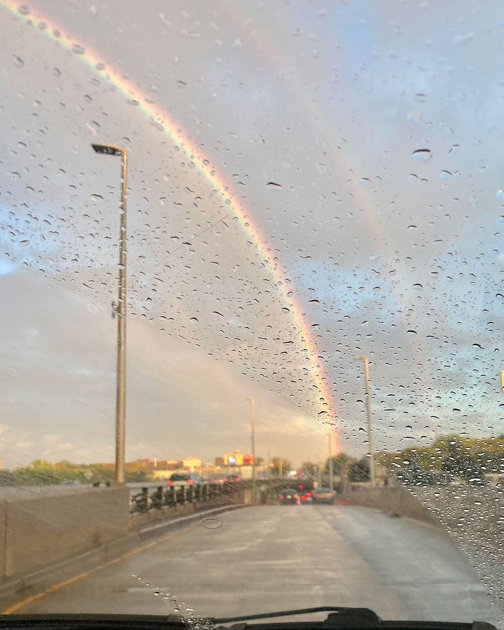 1000_molly_eleanor A rainbow viewed through a rain-specked car windshield.